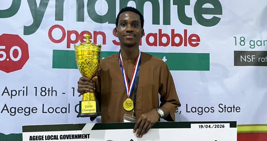 Micheal Ogbonna holding prize after winning Dynamite Opens Scrabble tournament in Lagos