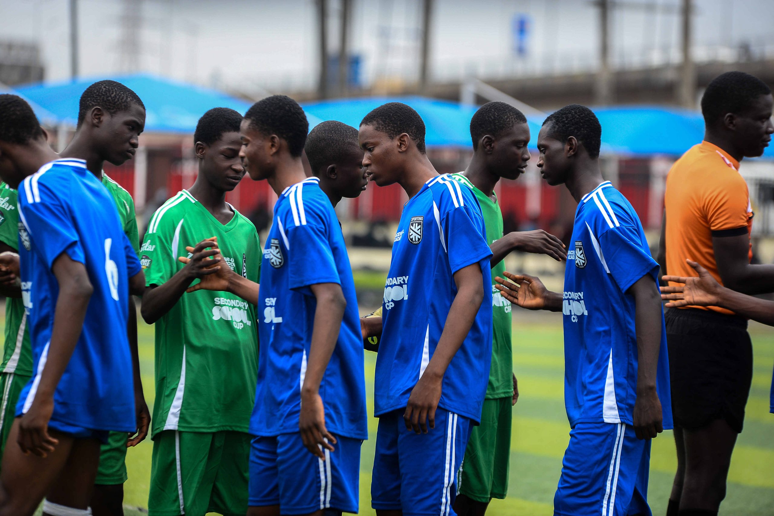 Young footballers compete during the Sporting Lagos Secondary School Cup at Elegbata Sports Complex, Lagos, as spectators cheer during the grassroots tournament.